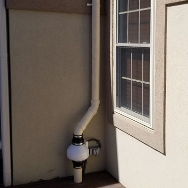 Radon mitigation system outside home.