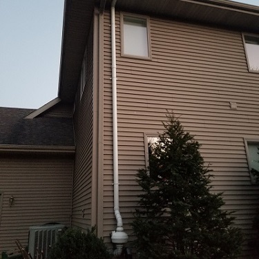 Radon mitigation system outside home.