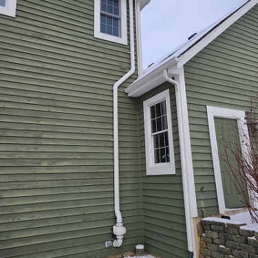 Radon mitigation system outside home.
