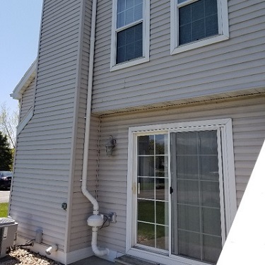 Radon mitigation system outside home.