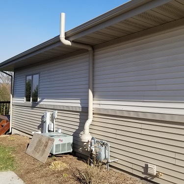 Radon mitigation system outside home.