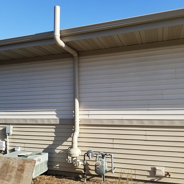 Radon mitigation system outside home.