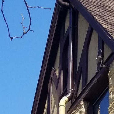 Radon mitigation system outside home.